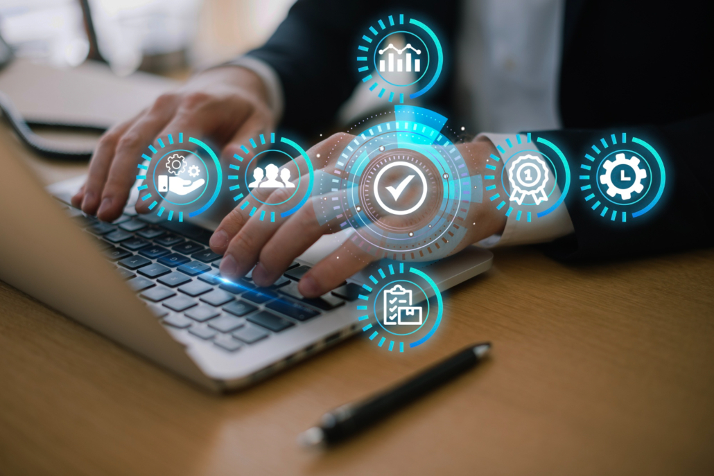 A business professional works on a laptop with endpoint management icons.